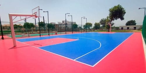 A basketball court with red and blue court lines, providing a vibrant and contrasting playing surface.